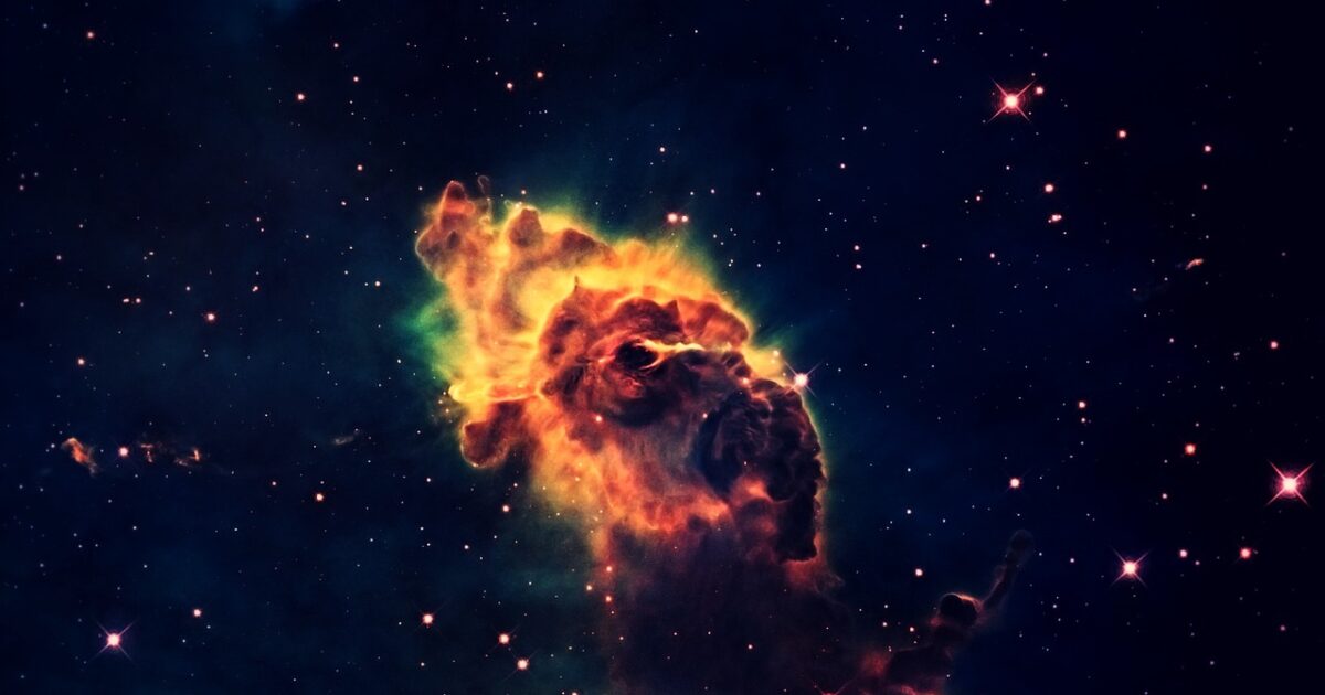 炎のように燃えるガス星雲と無数の星々